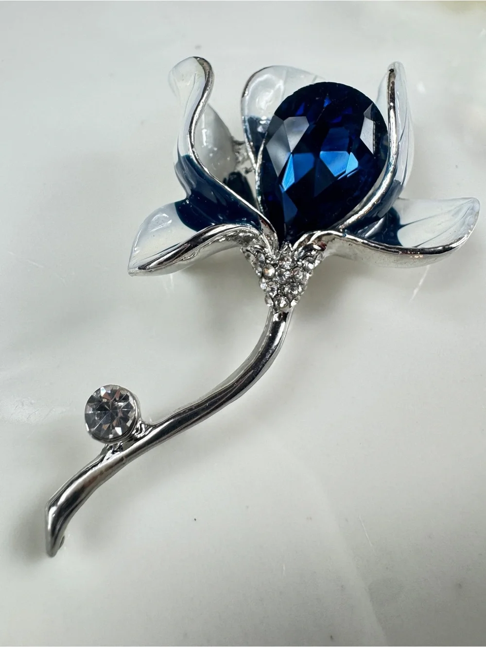 Silver Floral Brooch with Deep Blue Faceted Crystal